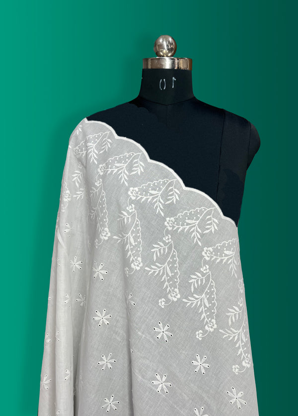 Floral border with all-over butti embroidery on cotton fabric.