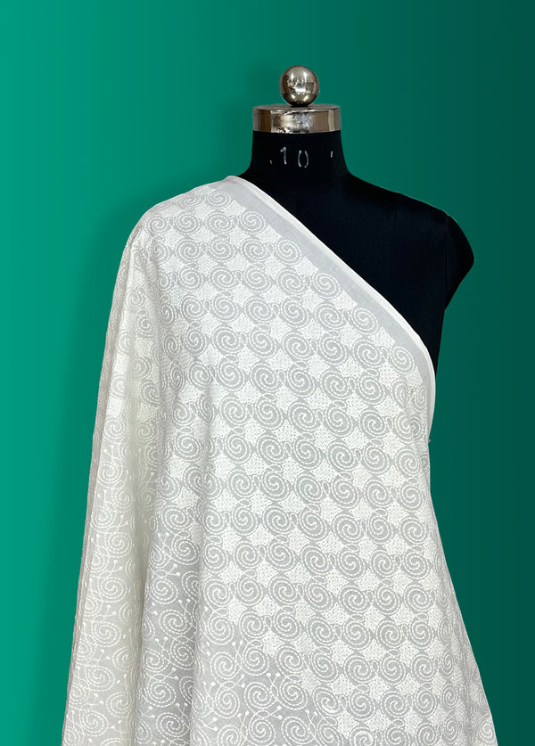 Geometrical border with all-over embroidery on cotton fabric.