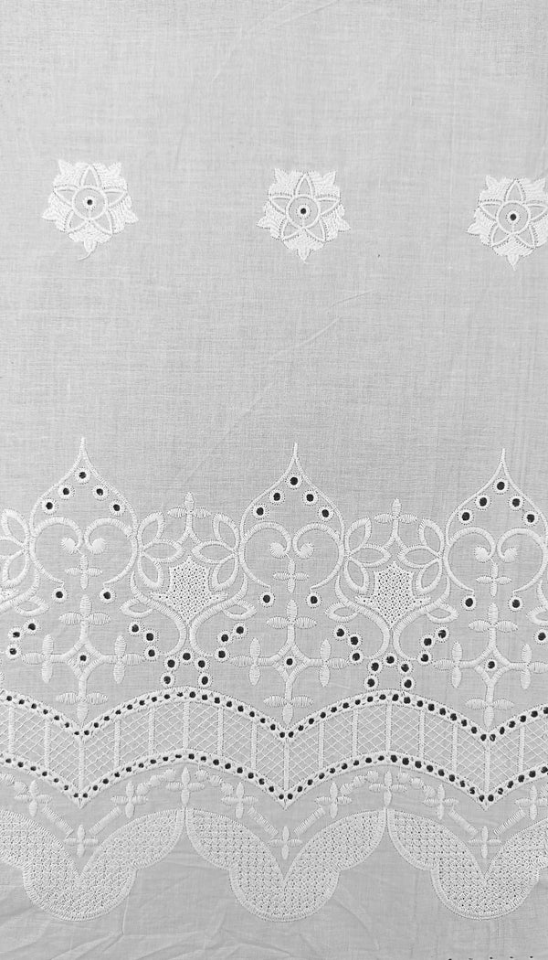 Floral border with all-over butti embroidery on cotton fabric.